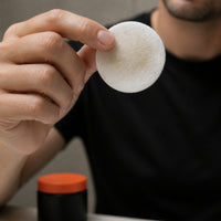 A used Unclog Pad held up to the light