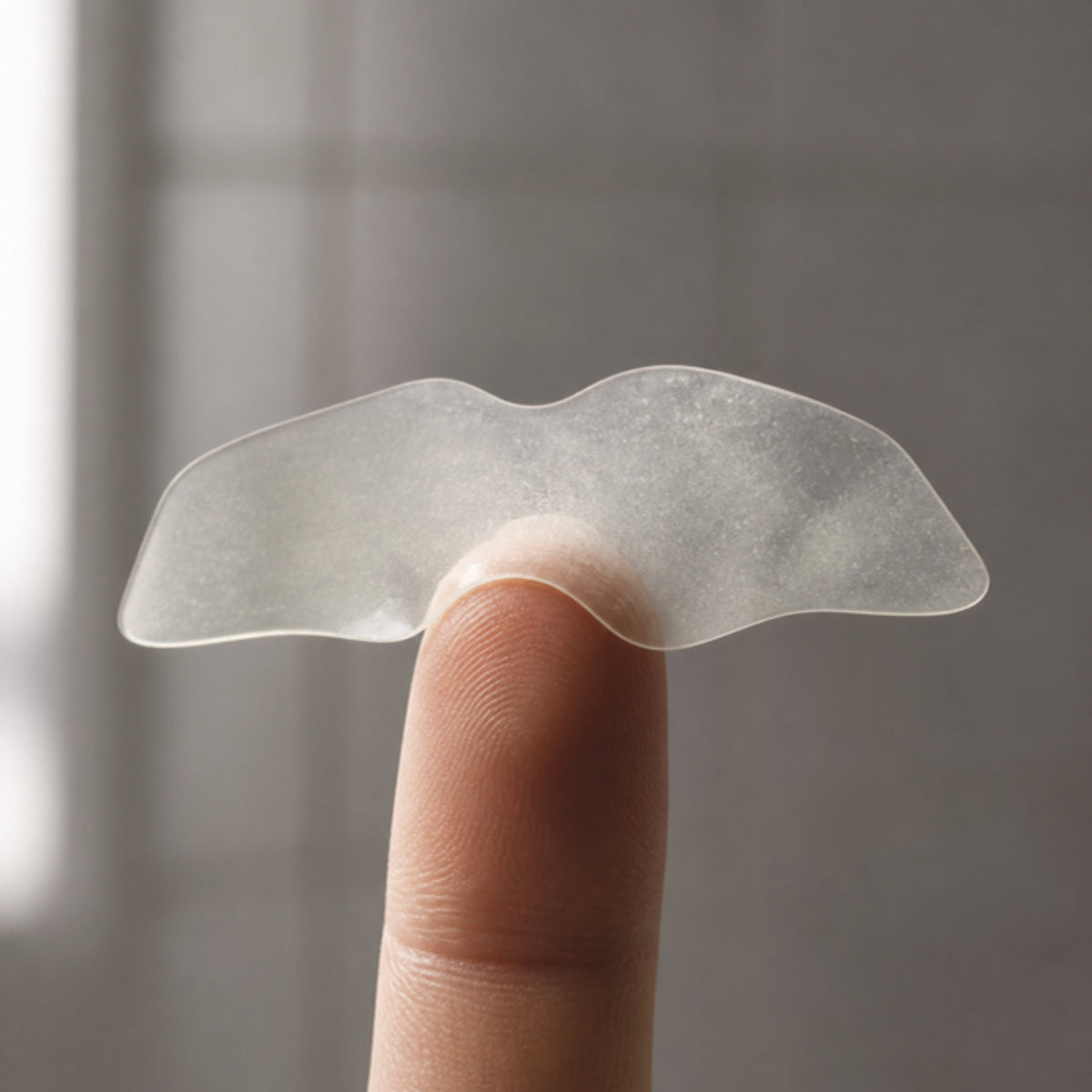 A peeled hydrocolloid Pull Patch on a fingertip